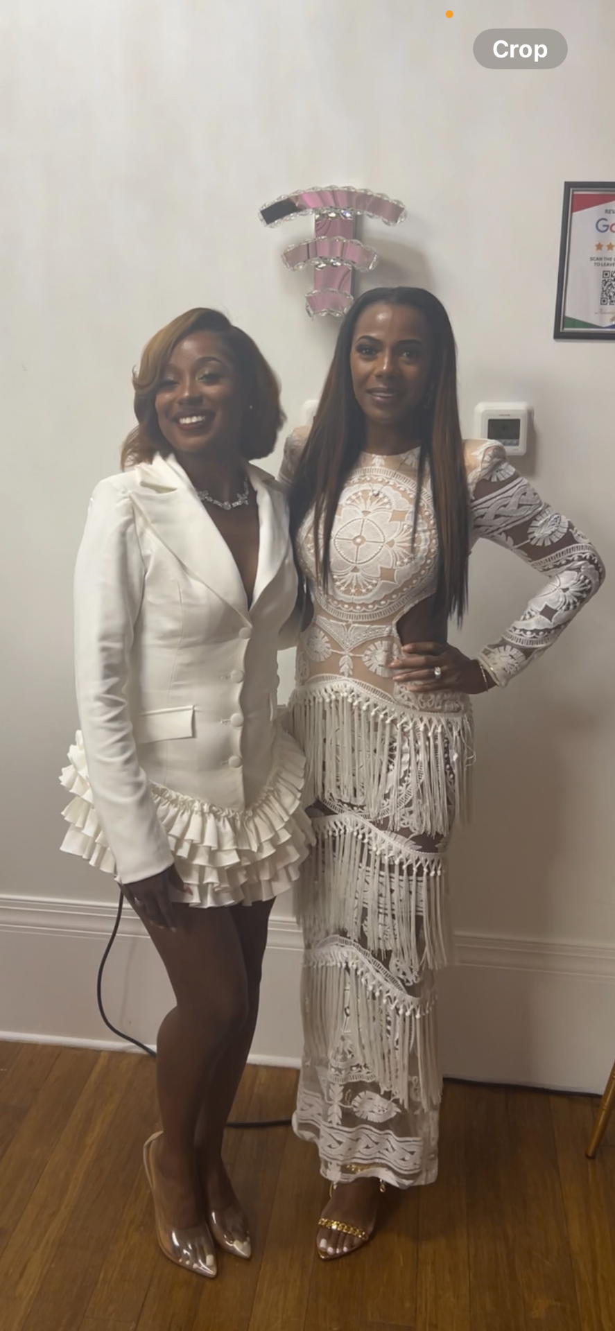 Ashley posing with a client in coordinated white looks